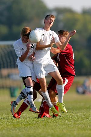 Cascade High School junior Chase Spencer (4) collides with  Cascade High School sophomore Zach Deurloo (7) as he goes for the header during the match between Danville and Cascade  at  Cascade High School in Clayton,IN. (Jeff Brown/Flyer Photo)