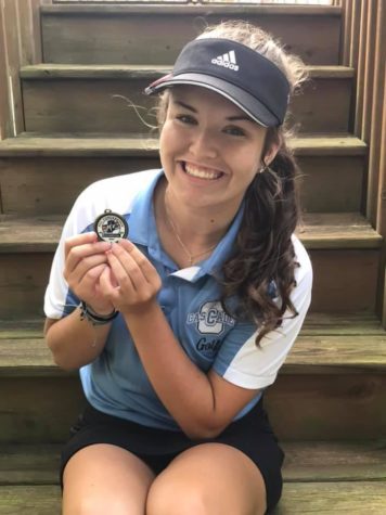 Third-year golfer, junior Addy Stevens with her Indiana Crossroads Conference hardware.